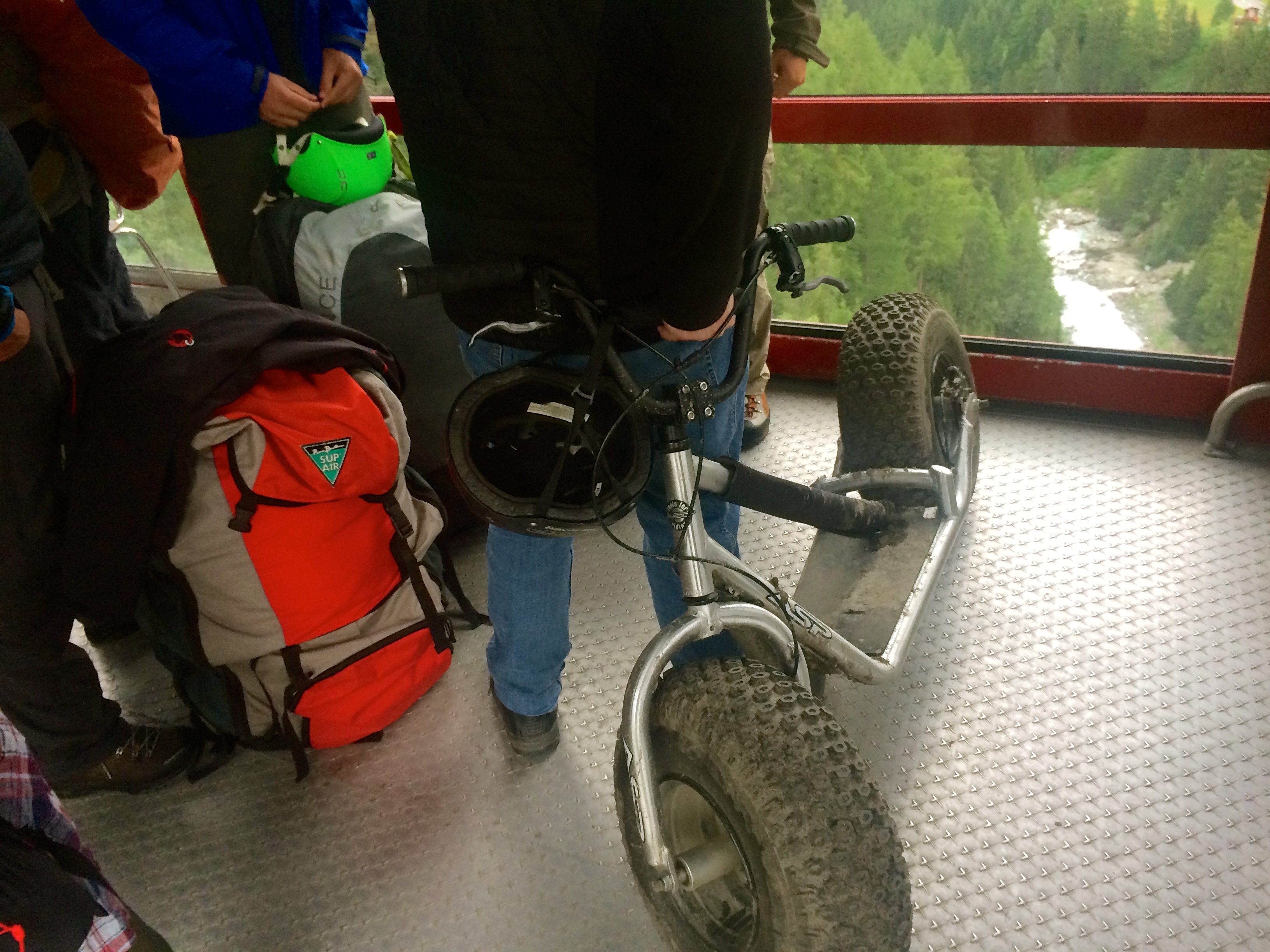 Funky rugged scooters and paragliding packs heading up the mountain